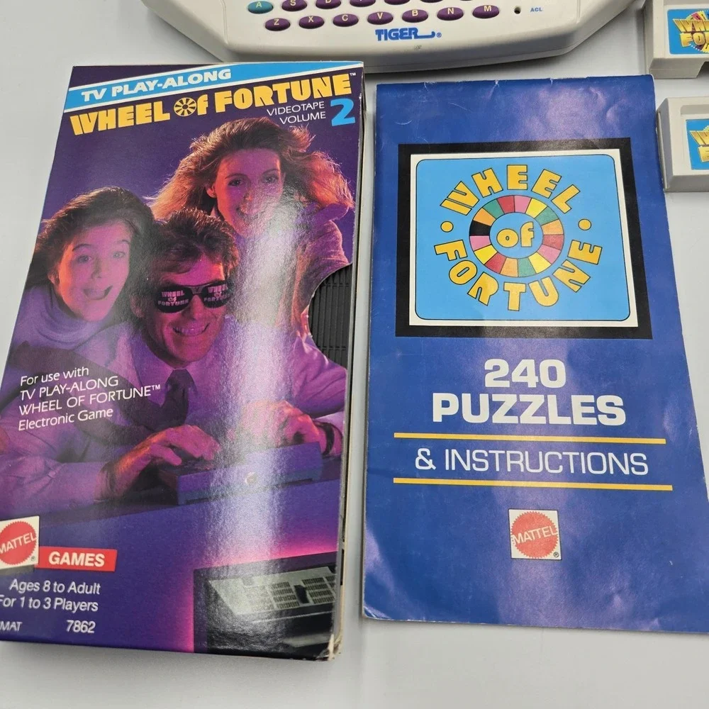 1995 Tiger Hand Held Electronic Wheel Of Fortune Expansion Cartridges Book & VHS